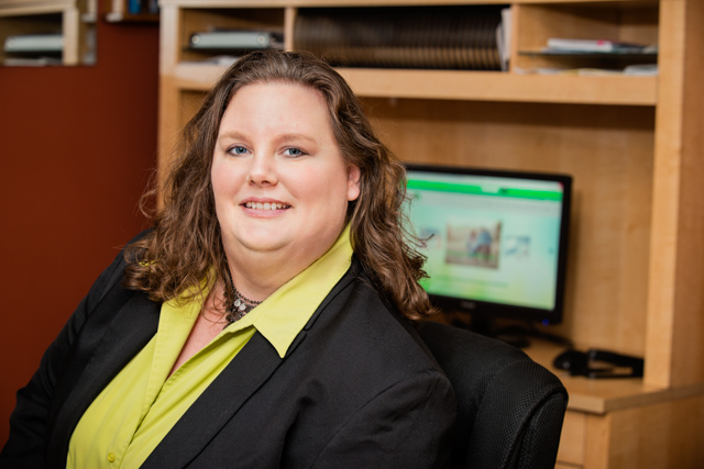 Kimberly Erick at her desk, reviewing a client's financials